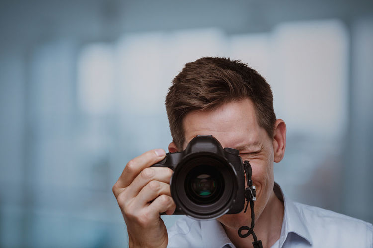 Photographer behind dslr camera