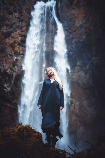 Young woman looking at waterfall