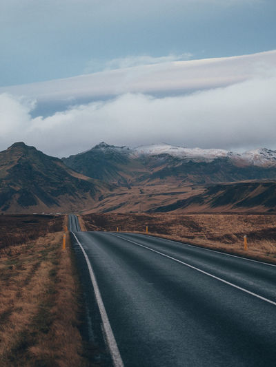 Empty road along countryside landscape