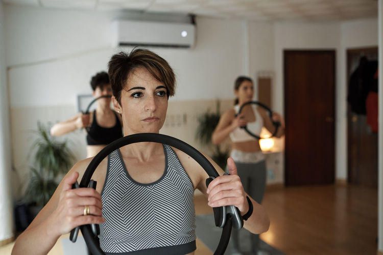 Group of women practicing pilates exercises in class