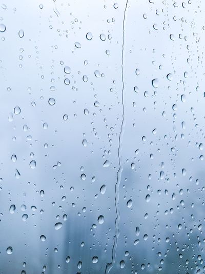 Full frame shot of wet glass window during rain