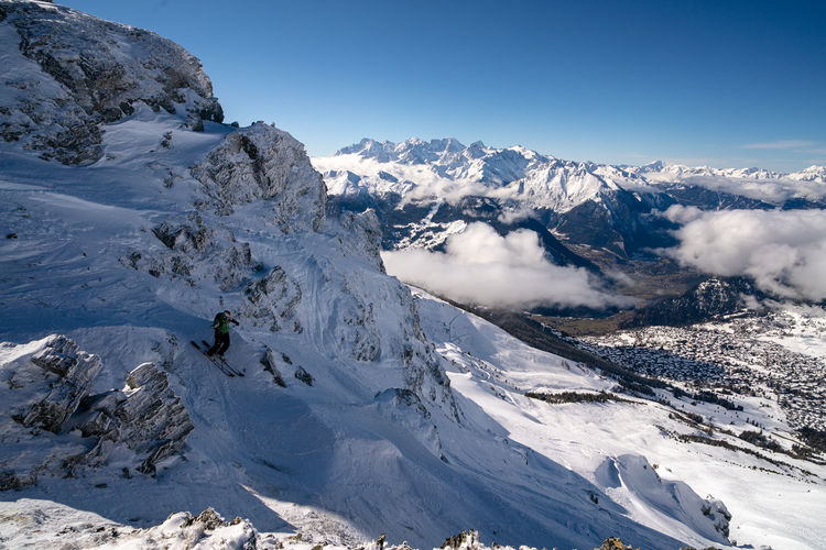 Scenic view of a skier on snowcapped mountains against verbier 