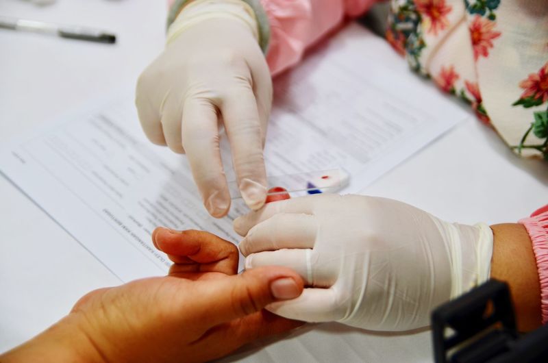 Cropped hands doing blood test of patient