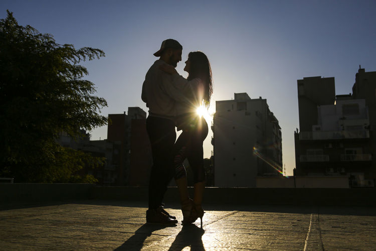 Couple dancing in a roof top in buenos aires 