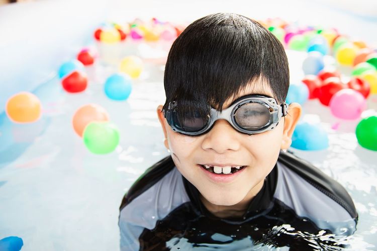 Portrait of smiling boy in wading pool