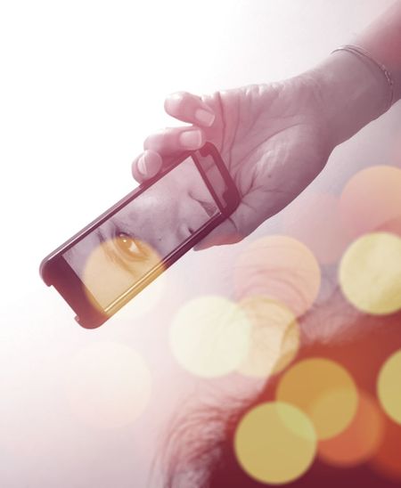 Close-up of woman holding hand over white background