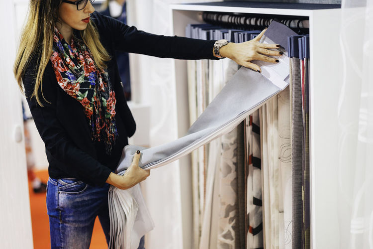 Woman choosing fabric at store