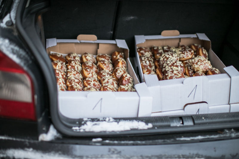 High angle view of donut boxes in car trunk