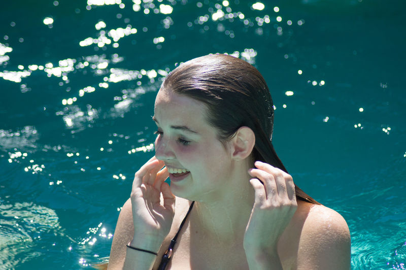 Close-up of woman enjoying in swimming pool