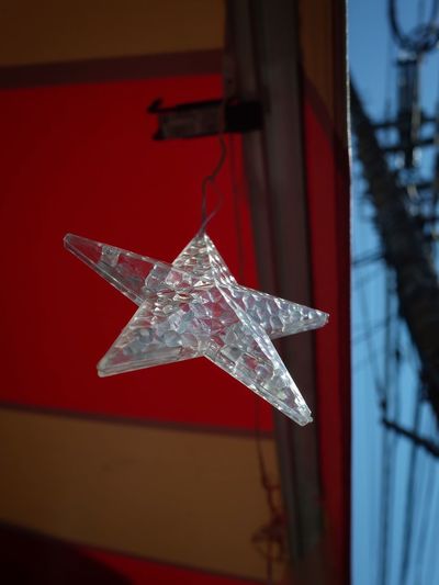 Close-up of christmas decorations hanging in snow