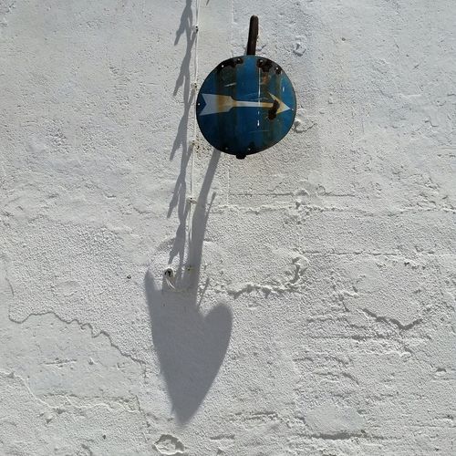 Close-up of hanging light against wall