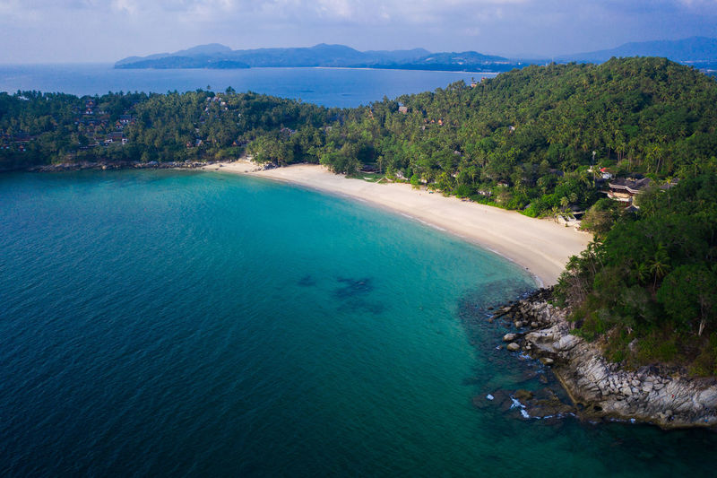 High angle view of sea and trees against sky