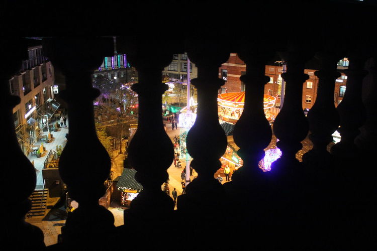 Panoramic shot of glass bottles on table at night