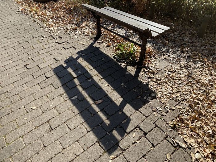 High angle view of park bench on street