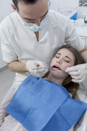 Dentist examining woman teeth in hospital