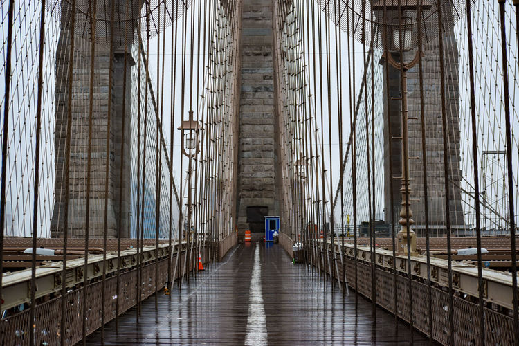 Brooklyn bridge in lower manhattan is seen on a rainy-foggy day, march 17, 2022 in new york city.