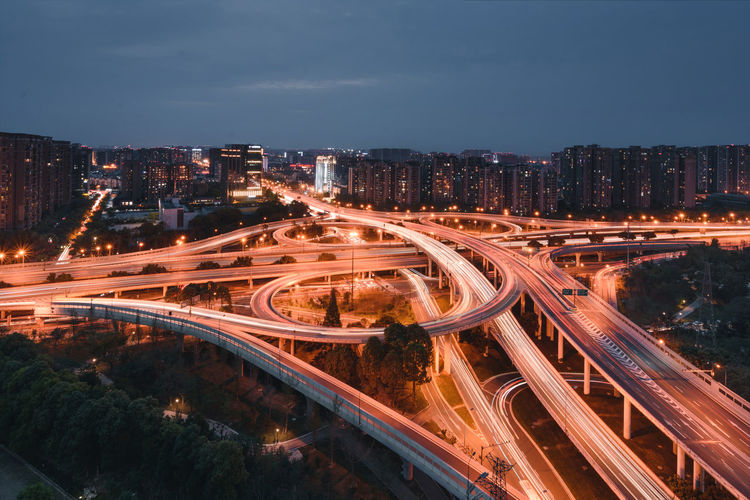 High angle view of light trails on highway in city at night