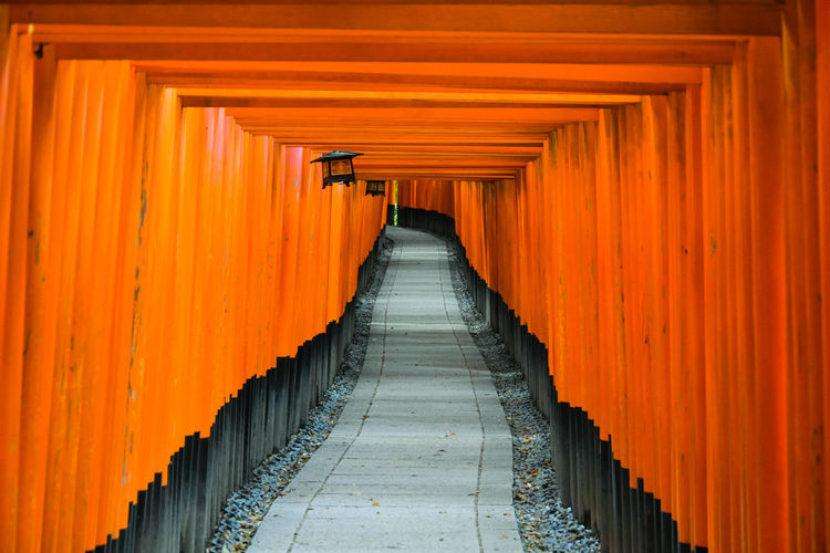 Vermillion gates at the fushimi inari shrine, kyoto, japan