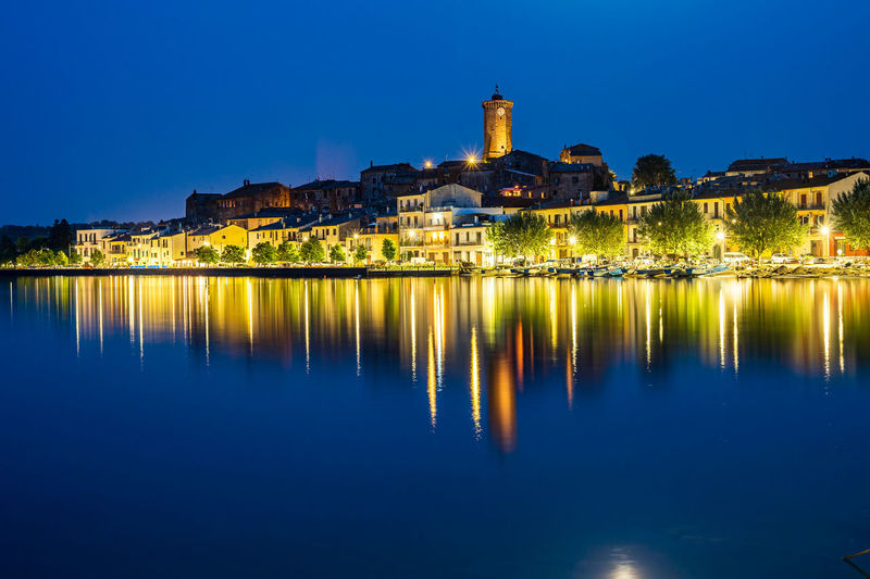 Nightview of the ancient village of marta, on the shore of bolsena lake in lazio, italy