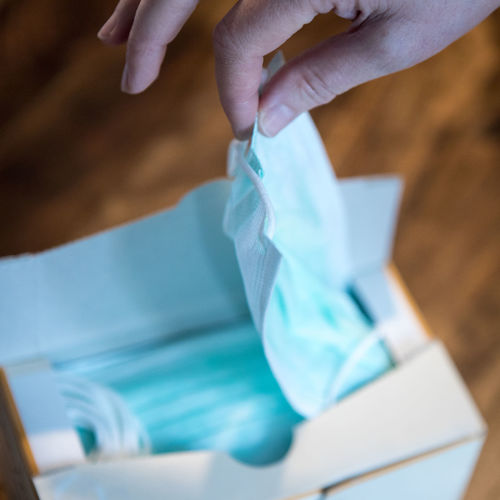 Midsection of woman holding paper with text on table