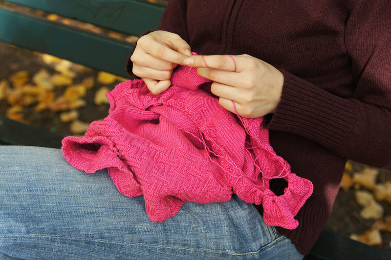 Midsection of woman holding pink toy