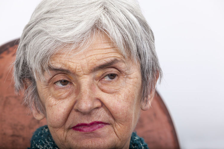 Close-up of senior woman sitting on chair