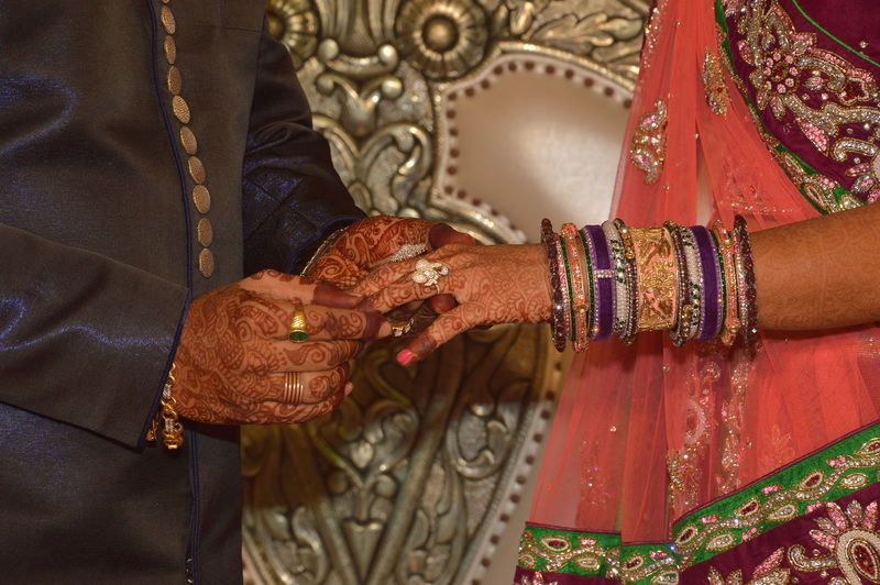 Couple holding hands on indian wedding