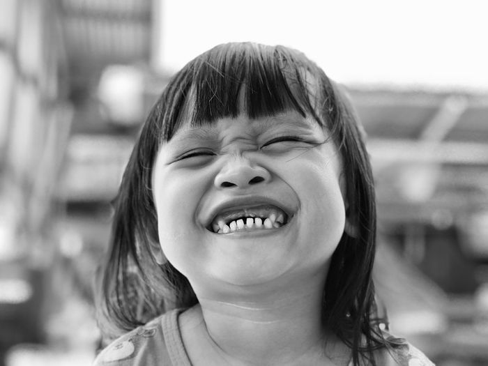 Close-up of smiling girl clenching teeth