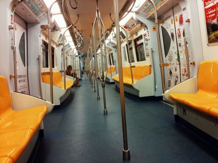 Yellow seats and metallic rods in train