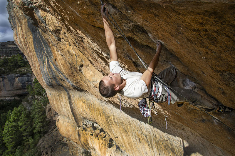 Full length of man climbing on rock