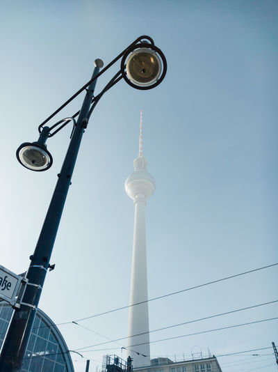 Low angle view of street light and fernsehturm against clear sky