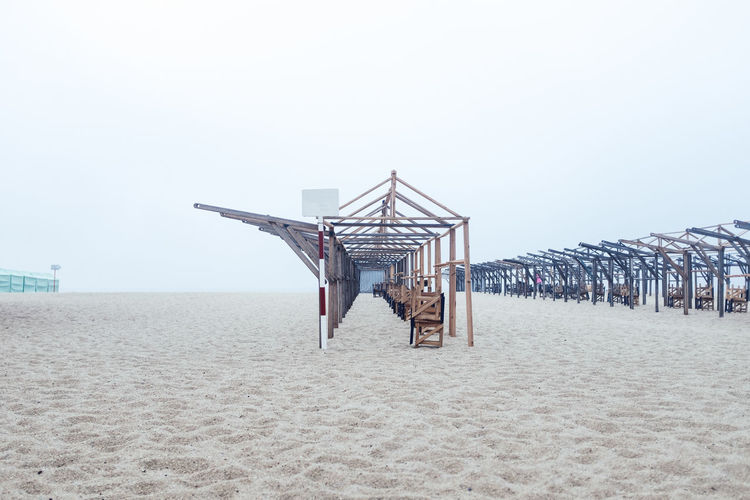Built structures on beach against clear sky