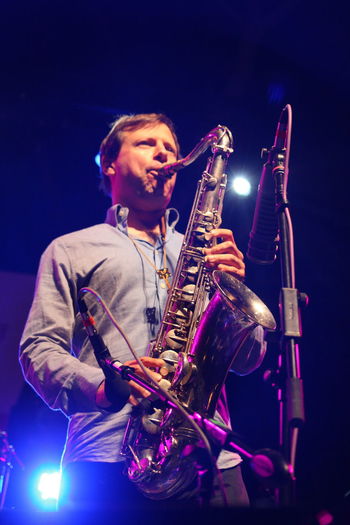 Low angle view of man playing musical instrument at concert