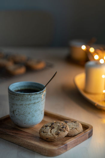 Christmas background with chocolate chip cookies, cup of tea. cozy evening, mug of drink, holiday 