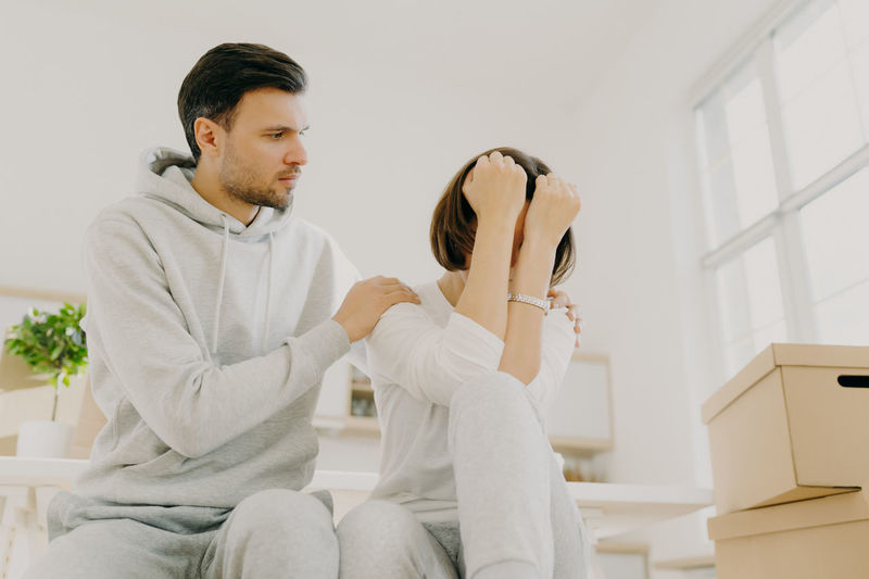 Couple sitting on table in room