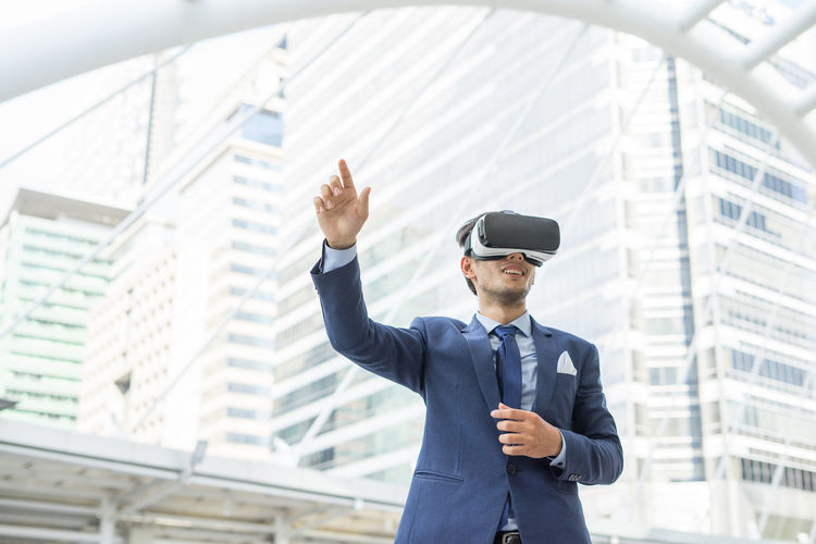 Businesssman using virtual reality stimulator in city