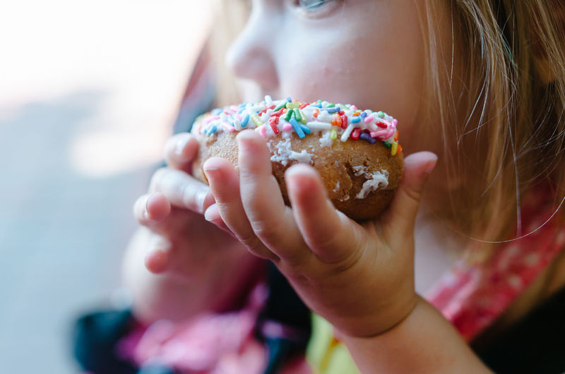 Close-up of girl holding donut