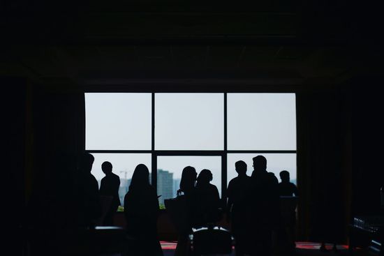 Silhouette people in board room during meeting at office
