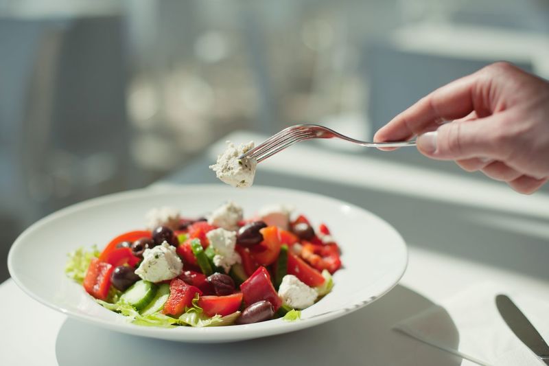 Cropped image of person holding salad