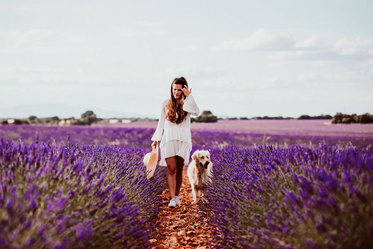 Woman with dog on lavender field