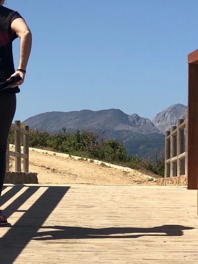 Shadow of man on mountain against clear sky