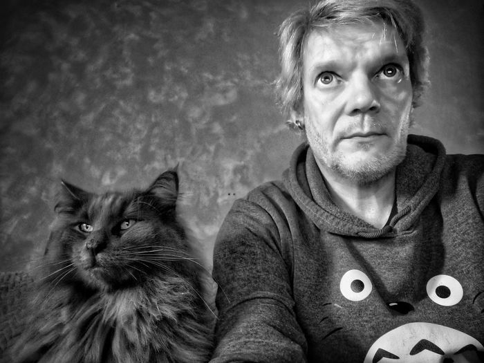 Portrait of man with cat