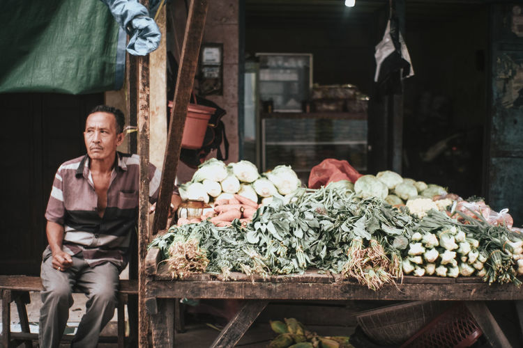 Portrait of man for sale at market stall