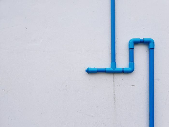 Close-up of blue pipe on wall