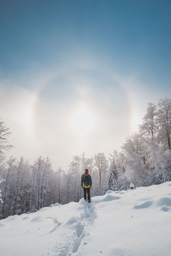 Adventurer enjoys phenomenon called the halo effect. winter scenery, beskydy mountains, czechia