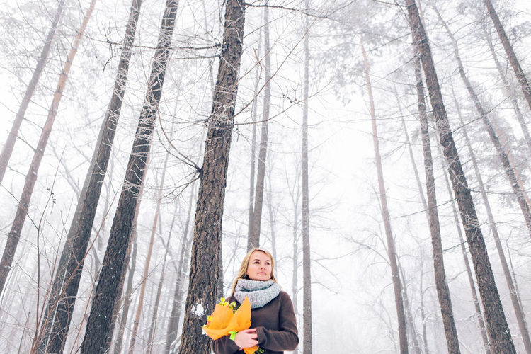 Full length of girl in snow covered forest