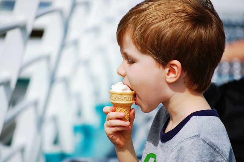 Side view of boy eating ice cream