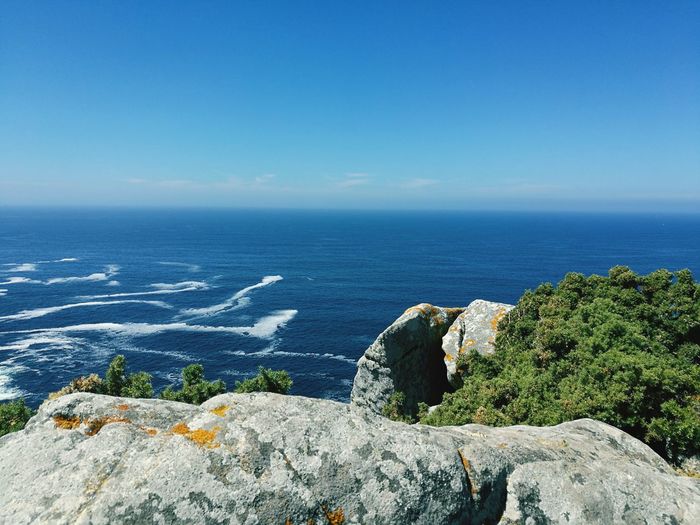 Scenic view of sea against clear blue sky