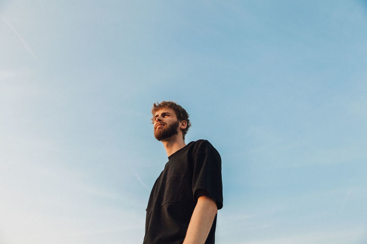 Low angle view of man standing against sky