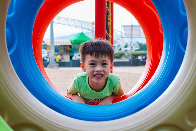 Portrait of happy boy playing in playground